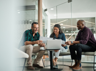 Menschen sitzen am Tisch und arbeiten gemeinsam