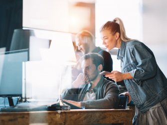 Mann und Frau schauen in Bildschirm und überlegen