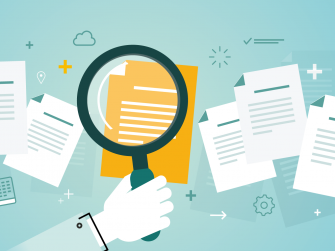 Hand hält Lupe in der Hand über einem Dokument