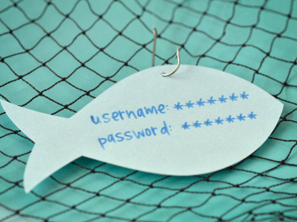 Fisch aus Papier liegt am Angelhaken in einem Netz